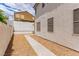 A low-maintenance backyard with stone ground cover and concrete walkway at 9740 Floweret Ave, Las Vegas, NV 89117