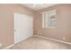 Bedroom featuring neutral tones and a closet with sliding doors for ample storage at 9740 Floweret Ave, Las Vegas, NV 89117