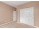 Bedroom features neutral tones and a closet with sliding doors for ample storage at 9740 Floweret Ave, Las Vegas, NV 89117