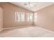 Bright bedroom with a ceiling fan and multiple windows offering serene views and natural light at 9740 Floweret Ave, Las Vegas, NV 89117