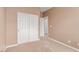 Bedroom featuring neutral tones and a closet with sliding doors for ample storage at 9740 Floweret Ave, Las Vegas, NV 89117