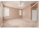 Vaulted-ceiling bedroom featuring a ceiling fan, window and plush carpeting create an inviting space at 9740 Floweret Ave, Las Vegas, NV 89117