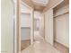 Hallway leading into closet with sliding doors and wire shelving and a door to the carpeted bedroom at 9740 Floweret Ave, Las Vegas, NV 89117