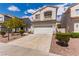 Beautiful two-story home with a two-car garage, xeriscaping, and manicured shrubbery at 9740 Floweret Ave, Las Vegas, NV 89117