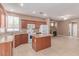 Well-lit kitchen features granite countertops, an island, and modern appliances for a delightful cooking experience at 9740 Floweret Ave, Las Vegas, NV 89117