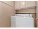 Bright laundry room featuring a side-by-side washer and dryer at 9740 Floweret Ave, Las Vegas, NV 89117
