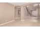 Open living space with arched entryways, tile floors, and staircase, creating a seamless flow at 9740 Floweret Ave, Las Vegas, NV 89117