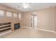 Comfortable living room featuring a fireplace, built-in shelves, tile flooring and neutral colors at 9740 Floweret Ave, Las Vegas, NV 89117