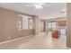 Open-concept living area with tile flooring, large archway, and access to kitchen and patio at 9740 Floweret Ave, Las Vegas, NV 89117