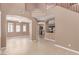 Spacious living area with tile flooring, arched doorways, and views into the kitchen and dining spaces at 9740 Floweret Ave, Las Vegas, NV 89117