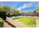 The backyard features a well-maintained lawn enclosed by a white picket fence at 977 Trackers Glen Ave, Henderson, NV 89015