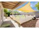 The backyard has a well-maintained lawn enclosed by a white picket fence and a patio at 977 Trackers Glen Ave, Henderson, NV 89015