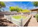 The backyard includes a well-maintained lawn enclosed by a white picket fence at 977 Trackers Glen Ave, Henderson, NV 89015