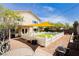 The backyard has a well-maintained lawn enclosed by a white picket fence at 977 Trackers Glen Ave, Henderson, NV 89015