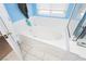 Bright bathroom showing a large soaking tub with white tile and clear shower enclosure for a clean and modern design at 977 Trackers Glen Ave, Henderson, NV 89015