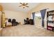 Spacious bedroom with a vaulted ceiling, large window, and neutral carpet creating a bright and versatile living area at 977 Trackers Glen Ave, Henderson, NV 89015