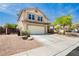 Inviting two-story home features a two-car garage, well-maintained landscaping, and a charming entrance at 977 Trackers Glen Ave, Henderson, NV 89015