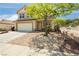 Charming two-story home showcasing a well-manicured rock garden at 977 Trackers Glen Ave, Henderson, NV 89015