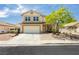 Charming two-story home featuring a well-maintained lawn and an attached two-car garage at 977 Trackers Glen Ave, Henderson, NV 89015