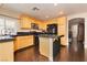 Well-lit kitchen featuring stainless steel appliances, a functional island, and wooden cabinetry for a blend of style and convenience at 977 Trackers Glen Ave, Henderson, NV 89015