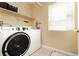 Laundry room featuring a washer, dryer, shelving and window at 977 Trackers Glen Ave, Henderson, NV 89015