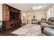 Relaxing living room featuring hardwood floors, neutral walls, and a large entertainment center at 977 Trackers Glen Ave, Henderson, NV 89015