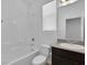 Bright bathroom featuring a shower-tub combo, a granite countertop and a dark wood vanity at 1063 Upper Springs St, Henderson, NV 89002