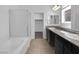 Bright bathroom with dual sinks, granite countertops, and a glass-enclosed shower at 1063 Upper Springs St, Henderson, NV 89002
