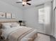 Bright bedroom with a ceiling fan, a wooden bed frame and neutral colored comforter set at 1063 Upper Springs St, Henderson, NV 89002