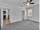 Bedroom with neutral paint, plush carpet, ceiling fan and views into the kitchen and hallway at 1063 Upper Springs St, Henderson, NV 89002