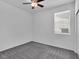 Bedroom featuring plush carpeting, a ceiling fan and a large window with blinds at 1063 Upper Springs St, Henderson, NV 89002
