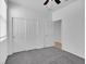 Bedroom with plush carpeting, a ceiling fan and a closet with bi-fold doors and an access door at 1063 Upper Springs St, Henderson, NV 89002