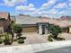 Charming single-story home featuring a well-manicured front yard, stone driveway and a two-car garage at 1063 Upper Springs St, Henderson, NV 89002