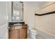 Clean bathroom with a shower-tub combo, granite countertops, and dark wood cabinets at 10748 Steel Ridge Ct, Las Vegas, NV 89135