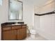 Clean bathroom with a shower-tub combo, granite countertops, and dark wood cabinets at 10748 Steel Ridge Ct, Las Vegas, NV 89135
