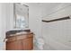 Well-lit bathroom with a vanity and a shower-over-tub with tiled walls at 10748 Steel Ridge Ct, Las Vegas, NV 89135