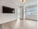 Bright bedroom with modern lighting, vinyl floors, and an exterior door to a balcony or patio at 10748 Steel Ridge Ct, Las Vegas, NV 89135