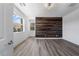 Bright bedroom featuring gray floors, statement wall, and large window with scenic view at 10748 Steel Ridge Ct, Las Vegas, NV 89135
