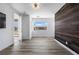 Bedroom boasts a stylish accent wall, wood floors, and a modern design at 10748 Steel Ridge Ct, Las Vegas, NV 89135