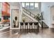 Grand entryway with high ceilings, a modern staircase, and a stylish bar area at 10748 Steel Ridge Ct, Las Vegas, NV 89135