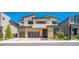 Contemporary two-story home showcasing a clean design with large windows and a three-car garage at 10748 Steel Ridge Ct, Las Vegas, NV 89135