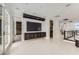 Spacious hallway with modern lighting, neutral tile floors, and a mounted flatscreen television at 10748 Steel Ridge Ct, Las Vegas, NV 89135