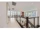 Bright hallway featuring modern art, stylish railings, and lots of natural light at 10748 Steel Ridge Ct, Las Vegas, NV 89135