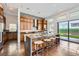 Stylish kitchen features an island with barstool seating and views of the backyard at 10748 Steel Ridge Ct, Las Vegas, NV 89135