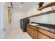 Functional laundry room with modern appliances, granite countertops, and ample storage at 10748 Steel Ridge Ct, Las Vegas, NV 89135