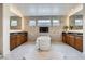 Main bathroom features dual sinks, a soaking tub and modern finishes at 10748 Steel Ridge Ct, Las Vegas, NV 89135