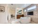 Bright bathroom features a soaking tub, walk-in shower, and stylish fixtures at 10748 Steel Ridge Ct, Las Vegas, NV 89135