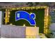 Aerial view of a backyard featuring a uniquely shaped pool, spa, and outdoor lights at 10748 Steel Ridge Ct, Las Vegas, NV 89135