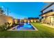 Backyard boasts a sparkling pool and spa, complemented by well-maintained artificial turf and ambient lighting at 1181 Calle De Luz, Henderson, NV 89012