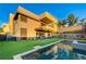 Stunning backyard with modern home, manicured lawn, beautiful landscaping, swimming pool, and outdoor seating area at 1181 Calle De Luz, Henderson, NV 89012